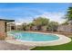 Backyard pool with brick and artificial grass at 3575 W Robindale Rd, Las Vegas, NV 89139