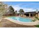 Swimming pool area surrounded by desert landscaping at 3575 W Robindale Rd, Las Vegas, NV 89139