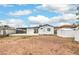 Spacious backyard featuring two sheds and covered patio with a blue sky at 40 Laswell St, Henderson, NV 89015