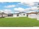 Expansive backyard with a covered patio and lush green lawn with storage shed at 40 Laswell St, Henderson, NV 89015