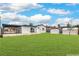Spacious backyard featuring a covered patio, verdant lawn, and convenient storage sheds at 40 Laswell St, Henderson, NV 89015