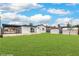 Spacious backyard featuring a covered patio, verdant lawn, and convenient storage sheds at 40 Laswell St, Henderson, NV 89015