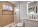 Modern bathroom showcases wood-look tile accent wall, sleek fixtures, floating vanity, and glass-enclosed shower at 40 Laswell St, Henderson, NV 89015