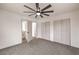 Bedroom featuring gray carpet, a modern ceiling fan, and double door closet storage at 40 Laswell St, Henderson, NV 89015