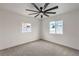 The bedroom features a ceiling fan, carpet, and two double-hung windows at 40 Laswell St, Henderson, NV 89015