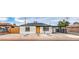 Charming single-story home with a bright orange door, low-maintenance landscaping, and covered parking area at 40 Laswell St, Henderson, NV 89015