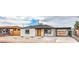 Picture of the home showcasing desert landscaping, single story with a covered parking area and a bright orange door at 40 Laswell St, Henderson, NV 89015