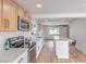 This kitchen has white countertops, new appliances, an island with seating, and hardwood floors at 40 Laswell St, Henderson, NV 89015