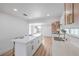 The kitchen has a quartz breakfast bar, modern appliances, and cabinets with beautiful hardware at 40 Laswell St, Henderson, NV 89015