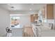 Stylish kitchen boasts white quartz countertops, new stainless appliances, and an island with seating at 40 Laswell St, Henderson, NV 89015