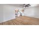 Spacious living room with wood-look floors, modern fan and seamless access to the updated kitchen at 40 Laswell St, Henderson, NV 89015