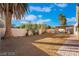 Spacious backyard with space, desert landscaping, and a covered patio area at 4209 Glass Lantern Dr, North Las Vegas, NV 89032