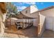 Backyard with desert landscaping and a trailer covered by a shade at 4209 Glass Lantern Dr, North Las Vegas, NV 89032