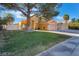 Two-story home boasting a lush green lawn and a mature tree, providing ample shade and curb appeal at 4209 Glass Lantern Dr, North Las Vegas, NV 89032