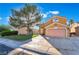 Inviting two-story home showcasing a spacious driveway, mature tree, and well-maintained lawn at 4209 Glass Lantern Dr, North Las Vegas, NV 89032