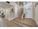 Bright foyer featuring tile floors, a staircase, and a chandelier, creating an inviting entrance at 4209 Glass Lantern Dr, North Las Vegas, NV 89032