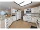 Spacious kitchen with white cabinets, granite countertops, stainless steel appliances and tile floors at 4209 Glass Lantern Dr, North Las Vegas, NV 89032