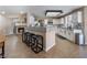 Open-concept kitchen with white cabinets, granite countertops, a large island, and stainless steel appliances at 4209 Glass Lantern Dr, North Las Vegas, NV 89032