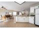 Bright open concept kitchen with white cabinets, tile floors, granite countertops, and eat-in dining area at 4209 Glass Lantern Dr, North Las Vegas, NV 89032