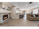 Inviting living room featuring a stone fireplace, tile floors, and an open layout connecting to the kitchen at 4209 Glass Lantern Dr, North Las Vegas, NV 89032