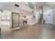 Open-concept living room featuring tile floors, a fireplace, and a staircase, providing a cozy and spacious atmosphere at 4209 Glass Lantern Dr, North Las Vegas, NV 89032