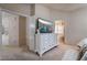 Bright main bedroom with plush carpet, an en suite bathroom, and a chest of drawers at 4209 Glass Lantern Dr, North Las Vegas, NV 89032