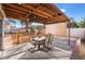 Spacious patio with a wooden pergola, seating, and desert landscaping at 4209 Glass Lantern Dr, North Las Vegas, NV 89032