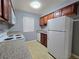 A practical kitchen equipped with wooden cabinetry, white appliances, and durable countertops at 4400 Sandy River Dr # 4, Las Vegas, NV 89103