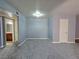 Spacious living room featuring neutral walls and new carpeting, leading to the bathroom and kitchen at 4400 Sandy River Dr # 4, Las Vegas, NV 89103