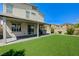 A backyard featuring artificial turf, a covered patio, and space for outdoor entertaining at 4503 Meteora Ledge Ave, North Las Vegas, NV 89084