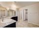 Bright bathroom featuring double sinks, granite countertops, and tile floors at 4503 Meteora Ledge Ave, North Las Vegas, NV 89084