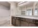 Modern bathroom features double sinks with granite counters and a tiled shower/tub combo at 4503 Meteora Ledge Ave, North Las Vegas, NV 89084