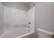 Bright bathroom featuring a shower and tub with white tile and updated fixtures at 4503 Meteora Ledge Ave, North Las Vegas, NV 89084
