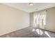Neutral bedroom with large window and plush carpeting at 4503 Meteora Ledge Ave, North Las Vegas, NV 89084