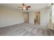 Spacious bedroom featuring a ceiling fan and doorways to the hallway and bathroom at 4503 Meteora Ledge Ave, North Las Vegas, NV 89084