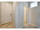 Clean entryway featuring neutral paint, tile floors, a white door, and access to other rooms at 4503 Meteora Ledge Ave, North Las Vegas, NV 89084