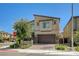 Inviting two-story home with desert landscaping, paver driveway, and a two-car garage in a modern community at 4503 Meteora Ledge Ave, North Las Vegas, NV 89084