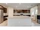 A spacious kitchen island with granite countertop and a stainless steel refrigerator at 4503 Meteora Ledge Ave, North Las Vegas, NV 89084