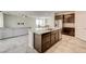 Open-concept kitchen with island, granite countertops, and seamless access to the adjacent living area at 4503 Meteora Ledge Ave, North Las Vegas, NV 89084