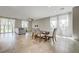Open-concept living and dining area with tile floors, neutral walls, and natural light at 4503 Meteora Ledge Ave, North Las Vegas, NV 89084