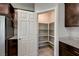 Walk-in pantry with white door and shelving, adjacent to the kitchen at 4503 Meteora Ledge Ave, North Las Vegas, NV 89084