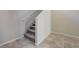 Neutral staircase with gray carpet and tile flooring; an electrical outlet visible on the wall at 4503 Meteora Ledge Ave, North Las Vegas, NV 89084