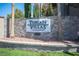 Community signage, 'Tuscan Villas', in an attractive stone wall and landscaping setting at 5055 W Hacienda Ave # 1097, Las Vegas, NV 89118