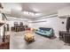 Spacious basement with concrete floors, a wood burning stove, bar area, and exposed white block walls at 5715 Gilbert Ln, Las Vegas, NV 89130