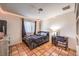 Cozy bedroom with a queen-size bed, a desk, bedside table, tiled floors and LED lighting at 5715 Gilbert Ln, Las Vegas, NV 89130
