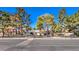Street view of the home showcasing its fence, front yard, and mature landscaping at 5715 Gilbert Ln, Las Vegas, NV 89130