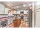 Functional kitchen with tile flooring, light cabinets, and stainless steel appliances providing a cozy cooking space at 5715 Gilbert Ln, Las Vegas, NV 89130