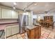 Functional kitchen with stainless steel appliances, ample storage and attached dining area at 5715 Gilbert Ln, Las Vegas, NV 89130
