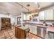 Traditional kitchen with terracotta tile flooring, wooden island, stainless steel appliances, and ample counter space at 5715 Gilbert Ln, Las Vegas, NV 89130