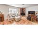 Cozy living room with Saltillo tile floors, brick fireplace, and comfortable seating at 5715 Gilbert Ln, Las Vegas, NV 89130